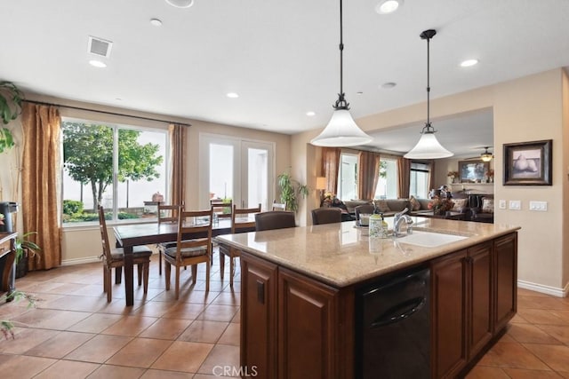 kitchen featuring sink, pendant lighting, a kitchen island, and light tile patterned floors