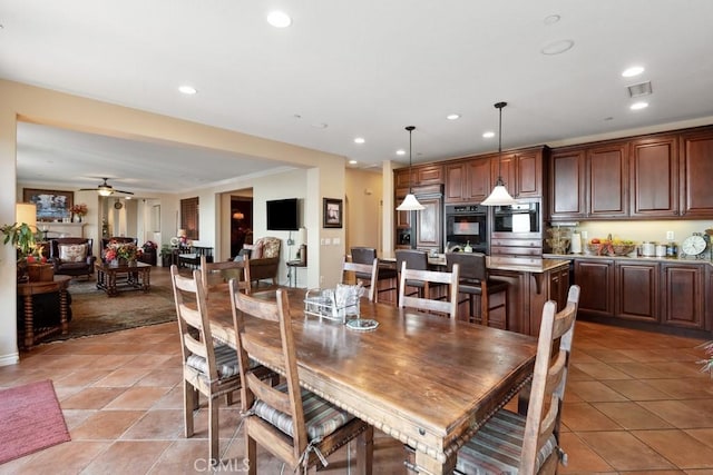 dining space with ceiling fan, light tile patterned floors, and crown molding