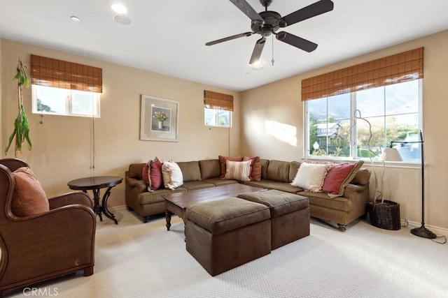 living room featuring ceiling fan and light colored carpet