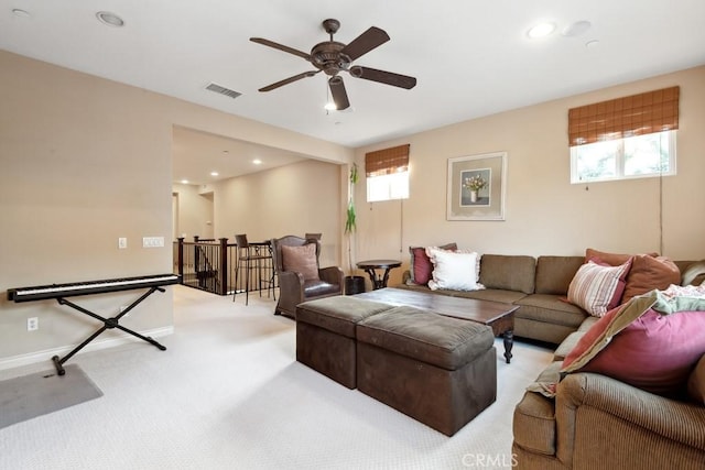 carpeted living room with ceiling fan and plenty of natural light