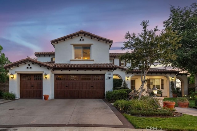 mediterranean / spanish-style house featuring a garage