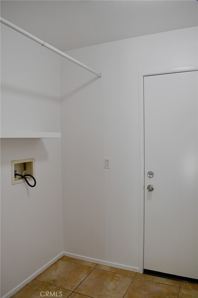 laundry room featuring hookup for a washing machine and light tile patterned floors