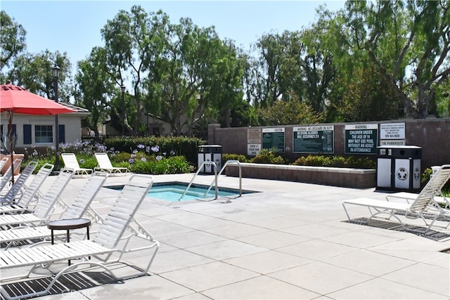 view of swimming pool with a patio area