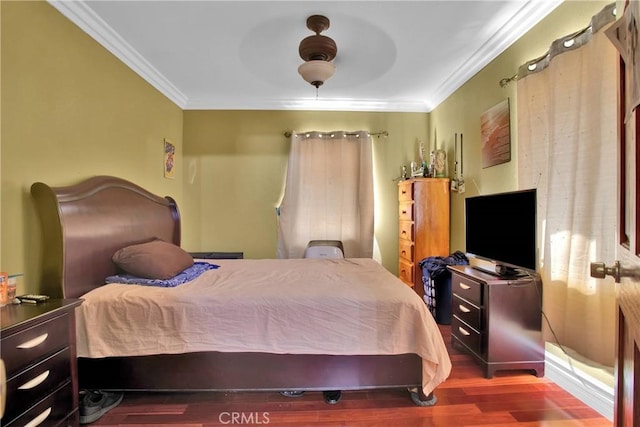 bedroom featuring ceiling fan, crown molding, and hardwood / wood-style flooring