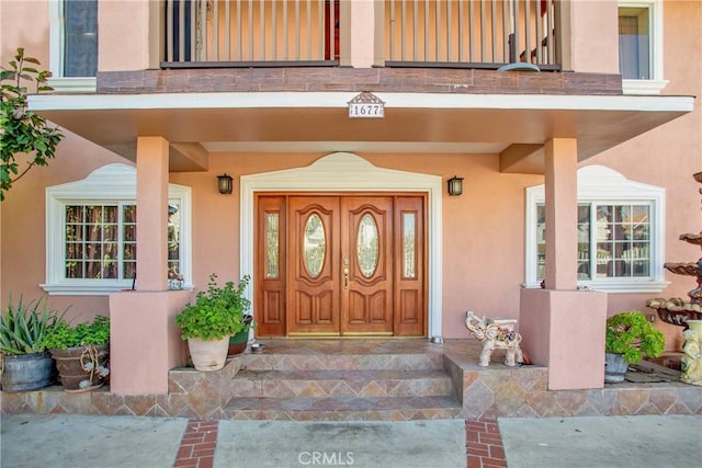 view of exterior entry featuring a porch