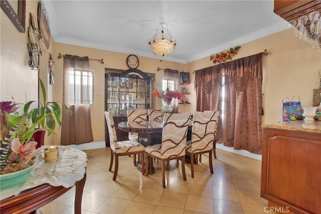 tiled dining room with ornamental molding and an inviting chandelier