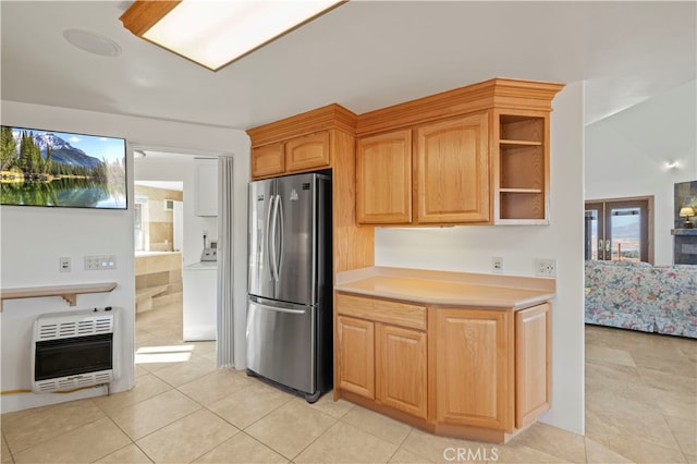 kitchen with stainless steel fridge, washer / dryer, light tile patterned flooring, and heating unit