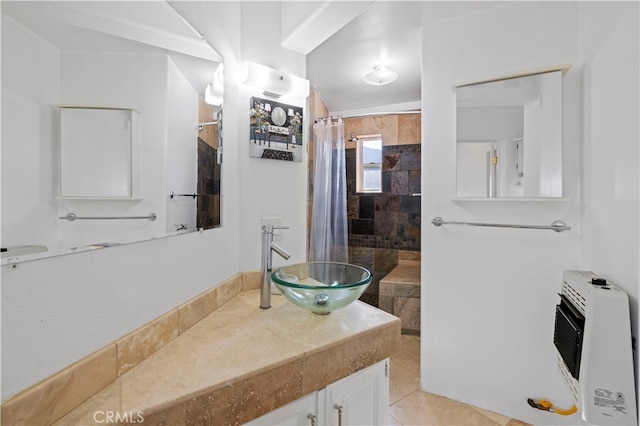 bathroom with vanity, heating unit, tile patterned floors, and a shower with shower curtain