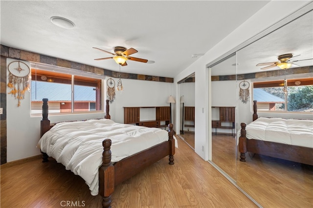 bedroom with light wood-type flooring and ceiling fan