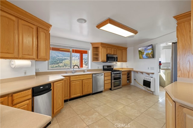 kitchen featuring light tile patterned floors, sink, stainless steel appliances, and heating unit