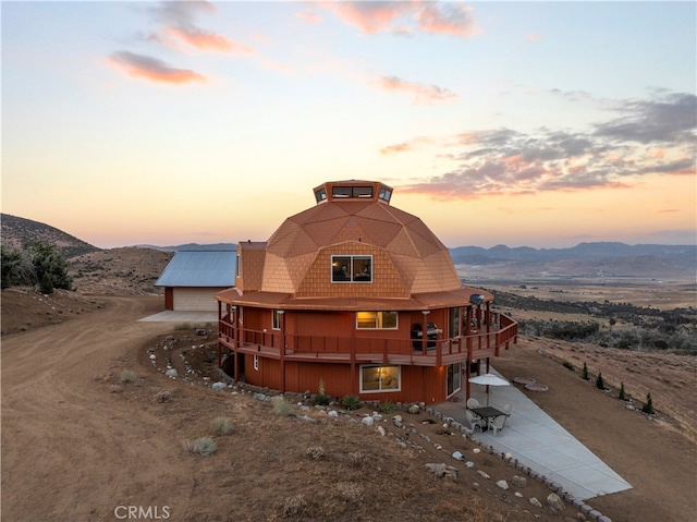 exterior space featuring a deck with mountain view