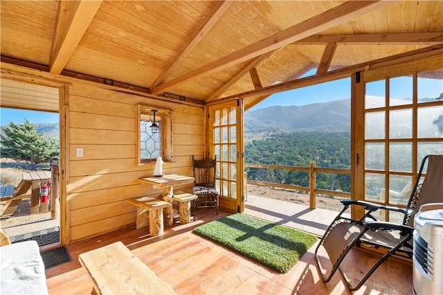 sunroom / solarium with wood ceiling, vaulted ceiling with beams, and a mountain view