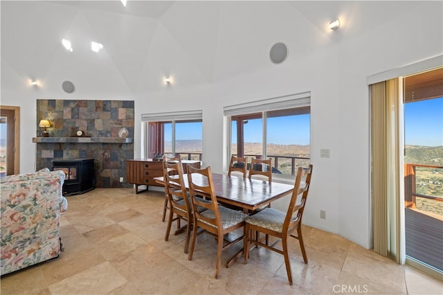 dining area with high vaulted ceiling