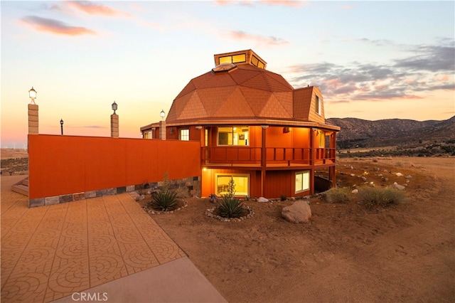 exterior space with a balcony and a mountain view