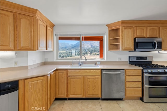 kitchen with light tile patterned floors, sink, and stainless steel appliances