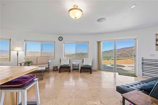 interior space with a mountain view and light tile patterned floors