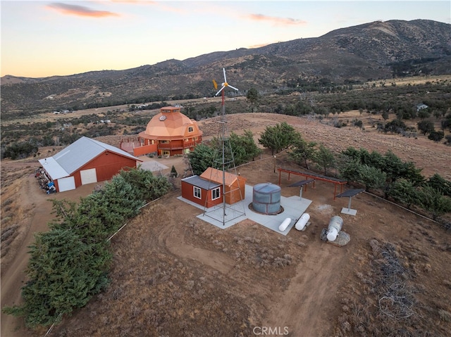 aerial view at dusk featuring a mountain view