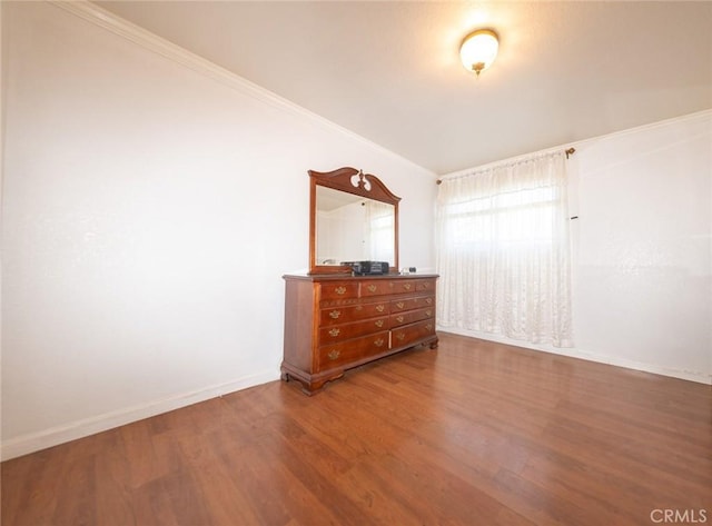 unfurnished bedroom with ornamental molding and wood-type flooring