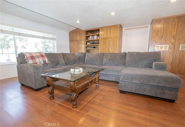 living room with hardwood / wood-style floors and built in features