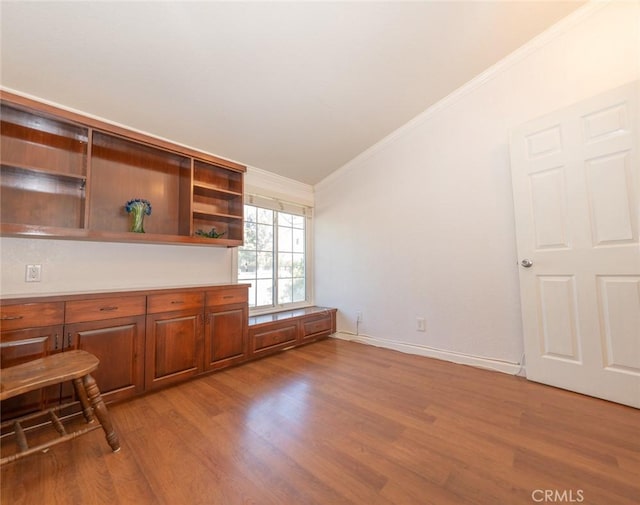 interior space with ornamental molding and light hardwood / wood-style floors