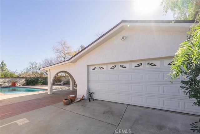 garage with a fenced in pool