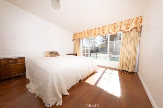 bedroom featuring wood-type flooring and lofted ceiling