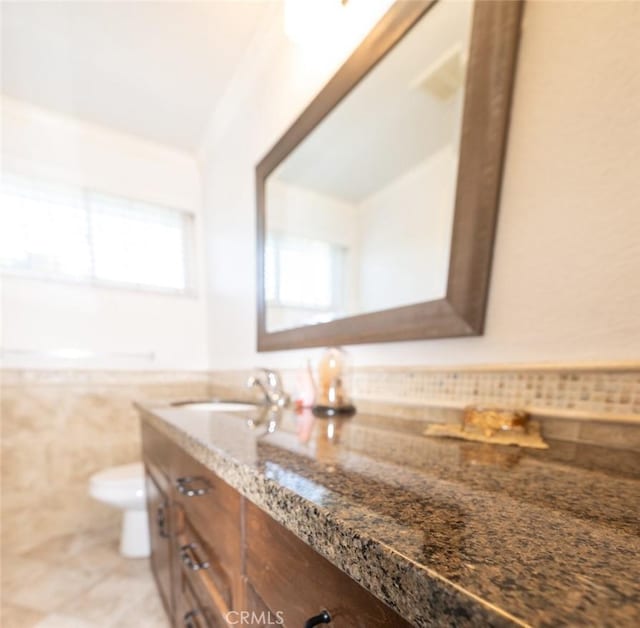 bathroom featuring vanity, tile patterned floors, and toilet