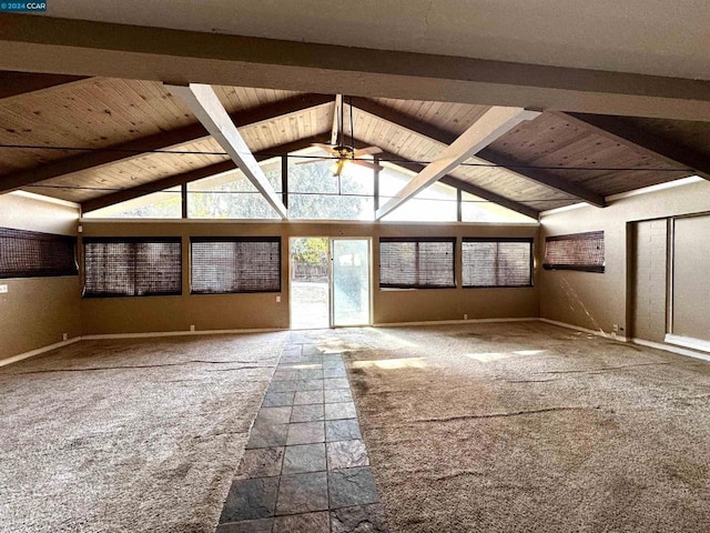 interior space featuring ceiling fan, vaulted ceiling with beams, carpet, and wood ceiling