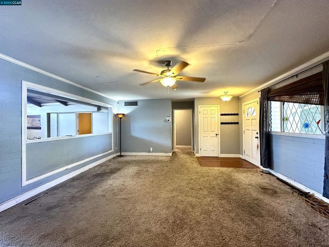 interior space with ceiling fan and ornamental molding