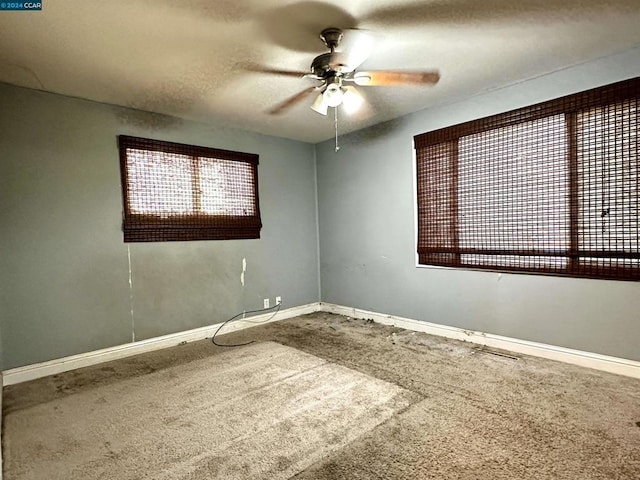 carpeted empty room featuring ceiling fan