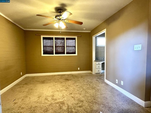 unfurnished bedroom featuring a textured ceiling, ceiling fan, carpet flooring, and crown molding