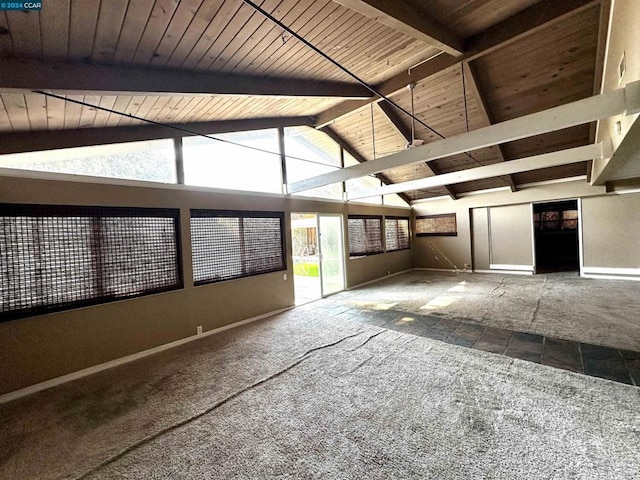 interior space with beam ceiling, a healthy amount of sunlight, and wooden ceiling