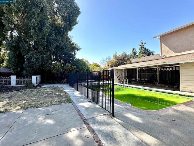 view of gate featuring a patio area