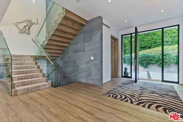 interior space featuring tile walls and hardwood / wood-style floors