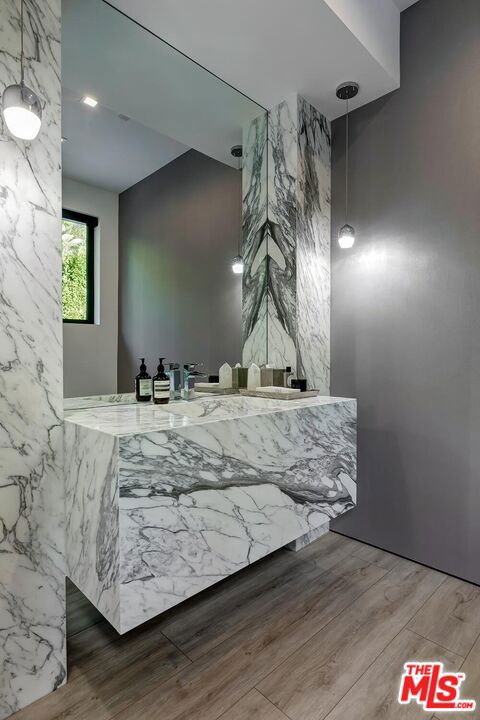 bathroom with hardwood / wood-style floors