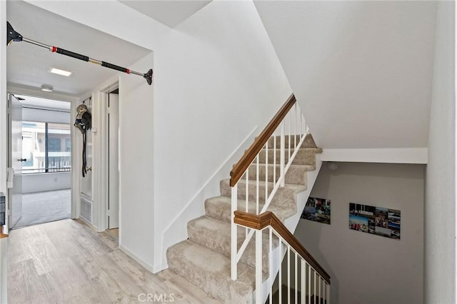 stairway with hardwood / wood-style flooring