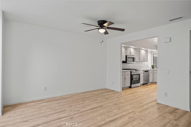 unfurnished living room with ceiling fan and light hardwood / wood-style flooring