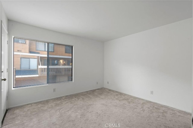 spare room with light colored carpet