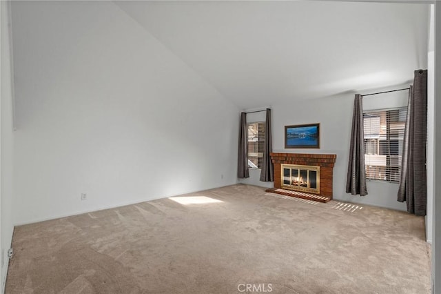 unfurnished living room featuring a healthy amount of sunlight, a brick fireplace, and carpet floors