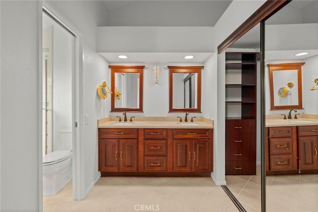 bathroom with tile patterned floors, vanity, and toilet