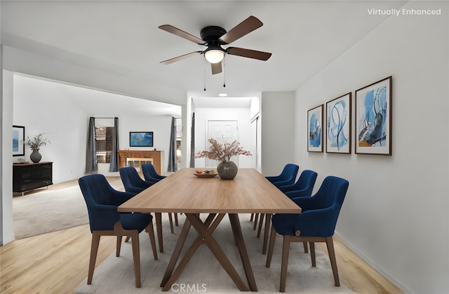 dining room with ceiling fan and light hardwood / wood-style flooring