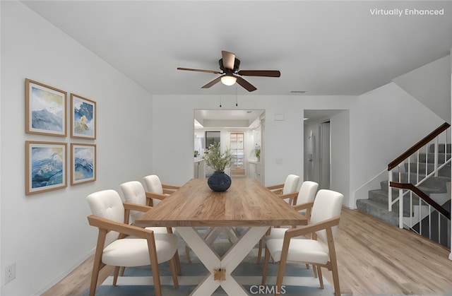 dining room with ceiling fan and light wood-type flooring