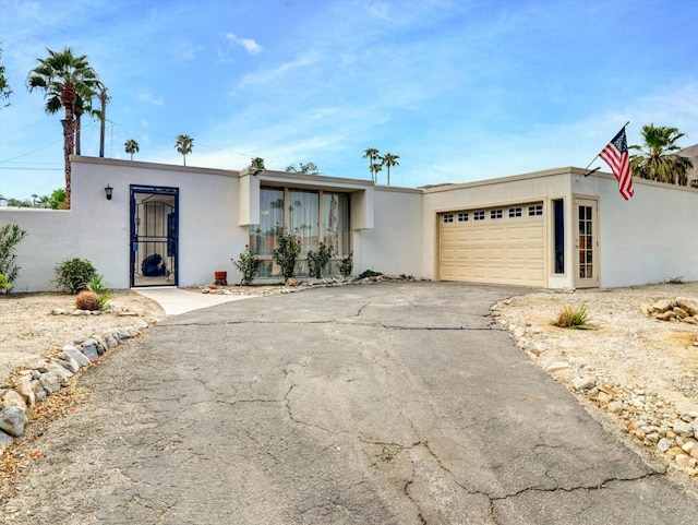 ranch-style home featuring a garage