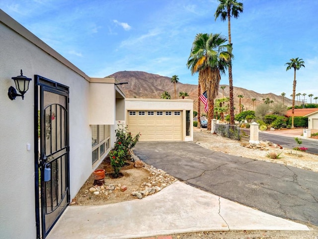 view of front of home with a mountain view and a garage