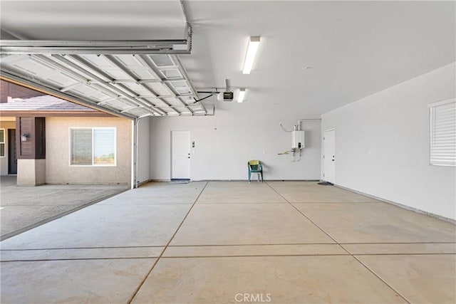 garage featuring water heater and a garage door opener