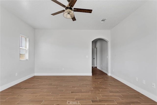 unfurnished room featuring ceiling fan, light hardwood / wood-style floors, and a textured ceiling