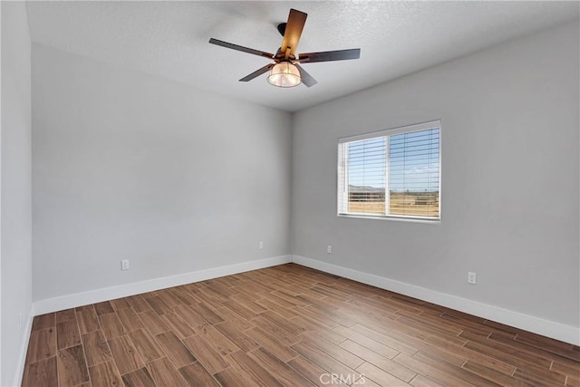 empty room with hardwood / wood-style flooring, ceiling fan, and a textured ceiling