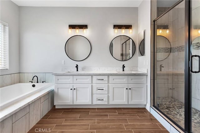 bathroom with vanity and shower with separate bathtub