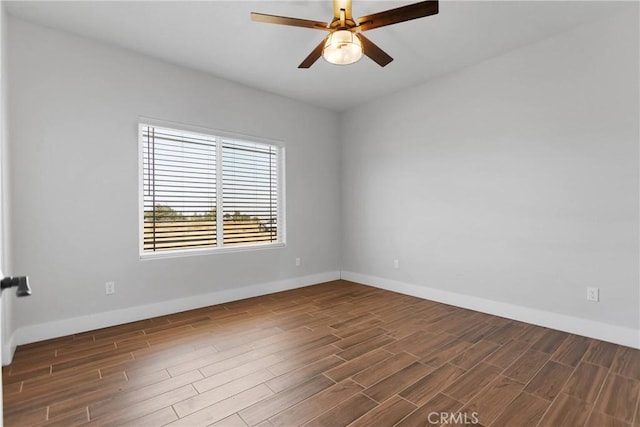 spare room featuring ceiling fan and dark hardwood / wood-style flooring