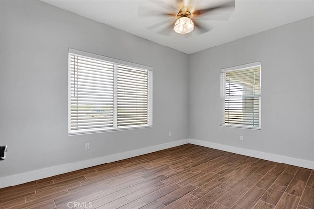 spare room featuring ceiling fan and hardwood / wood-style floors